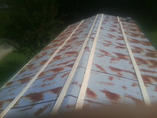 Rusted metal roof panels with new wood purlins before replacement — Storm Damage Roof Repair in Hawesville by Roofing Brothers