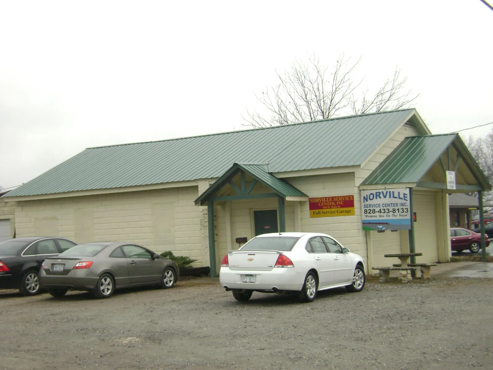 Green metal roof on a service garage with a covered entry in Hawesville